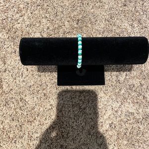 A green and white bracelet with gold beads. Hand made and great to wear!